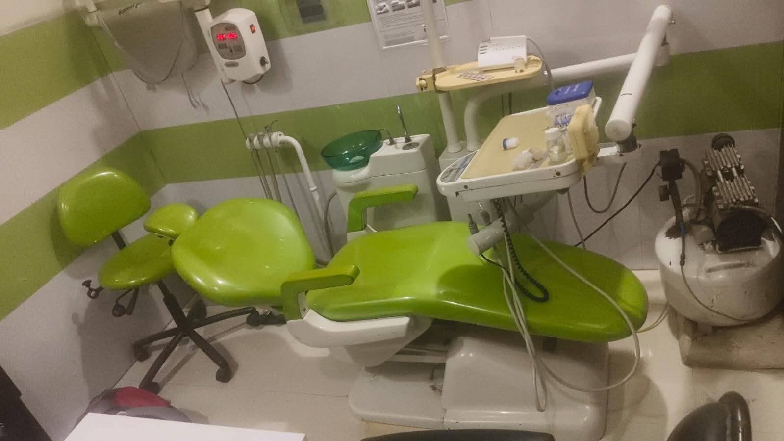 Green dental chair unit with doctor's stool and air compressor — ₹45,000