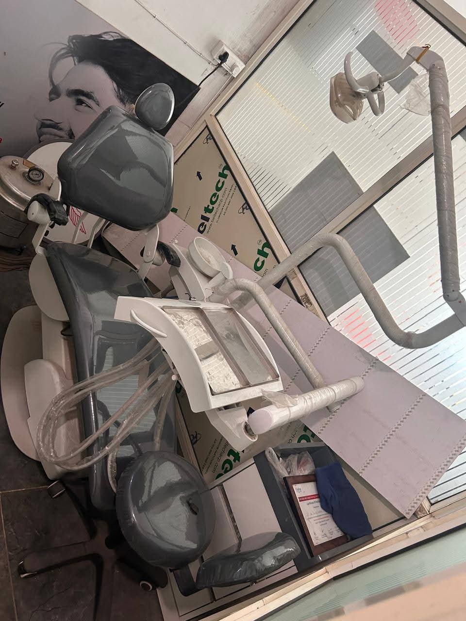 Grey dental chair unit with air compressor — sold by a dental technician, Faridabad